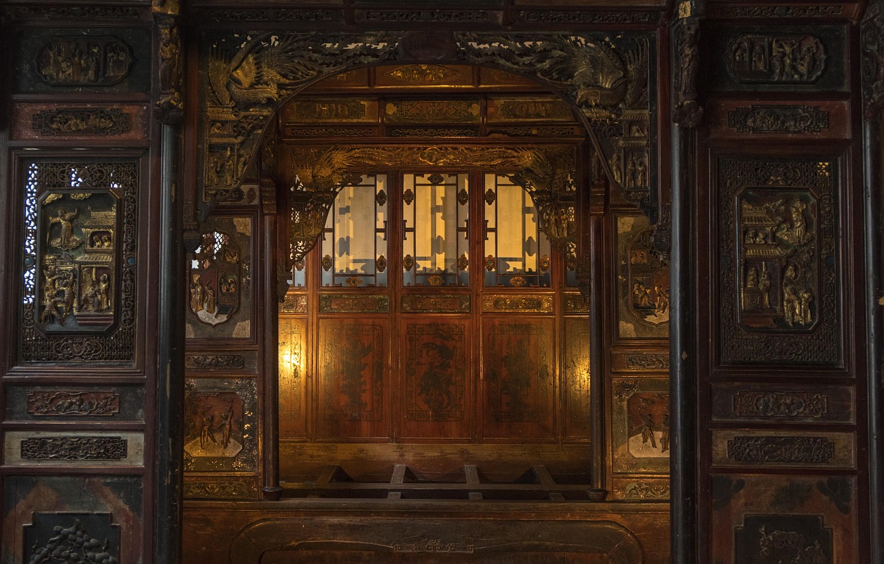 Ornately carved traditional wood doorway with gilded detail